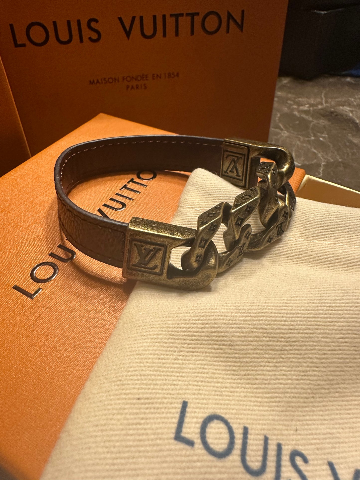 Louis Vuitton bracelet, brown leather and gold links