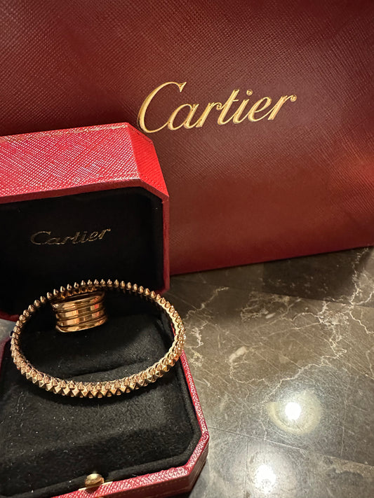 Cartier bullet design, rose gold. Pictured with Bulgari rose ring, size 6, not included.